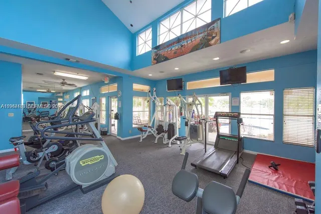a room with furniture a large window and glass door