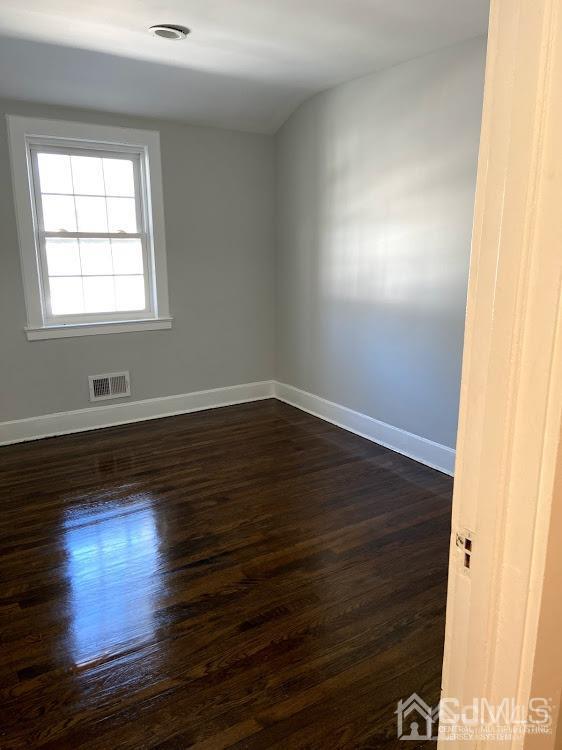 55 Devon Road, Unit A Colonia, NJ 07067 - Photo 8 of 10 an empty room with wooden floor and windows