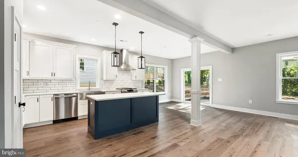 a kitchen with a stove a sink and a refrigerator