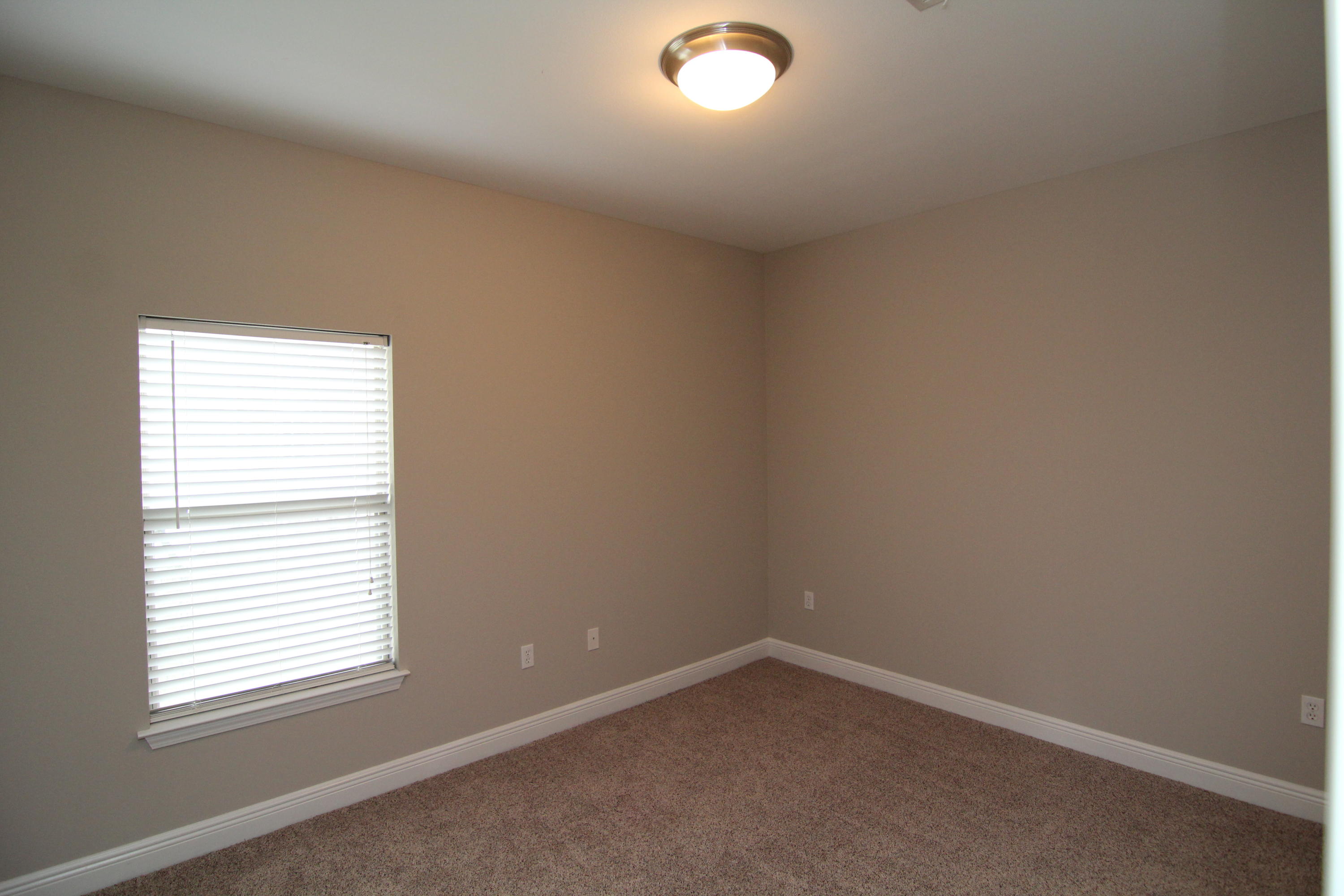 607 Rowan Circle Crestview, FL 32536 - Photo 11 of 17 an empty room with a window