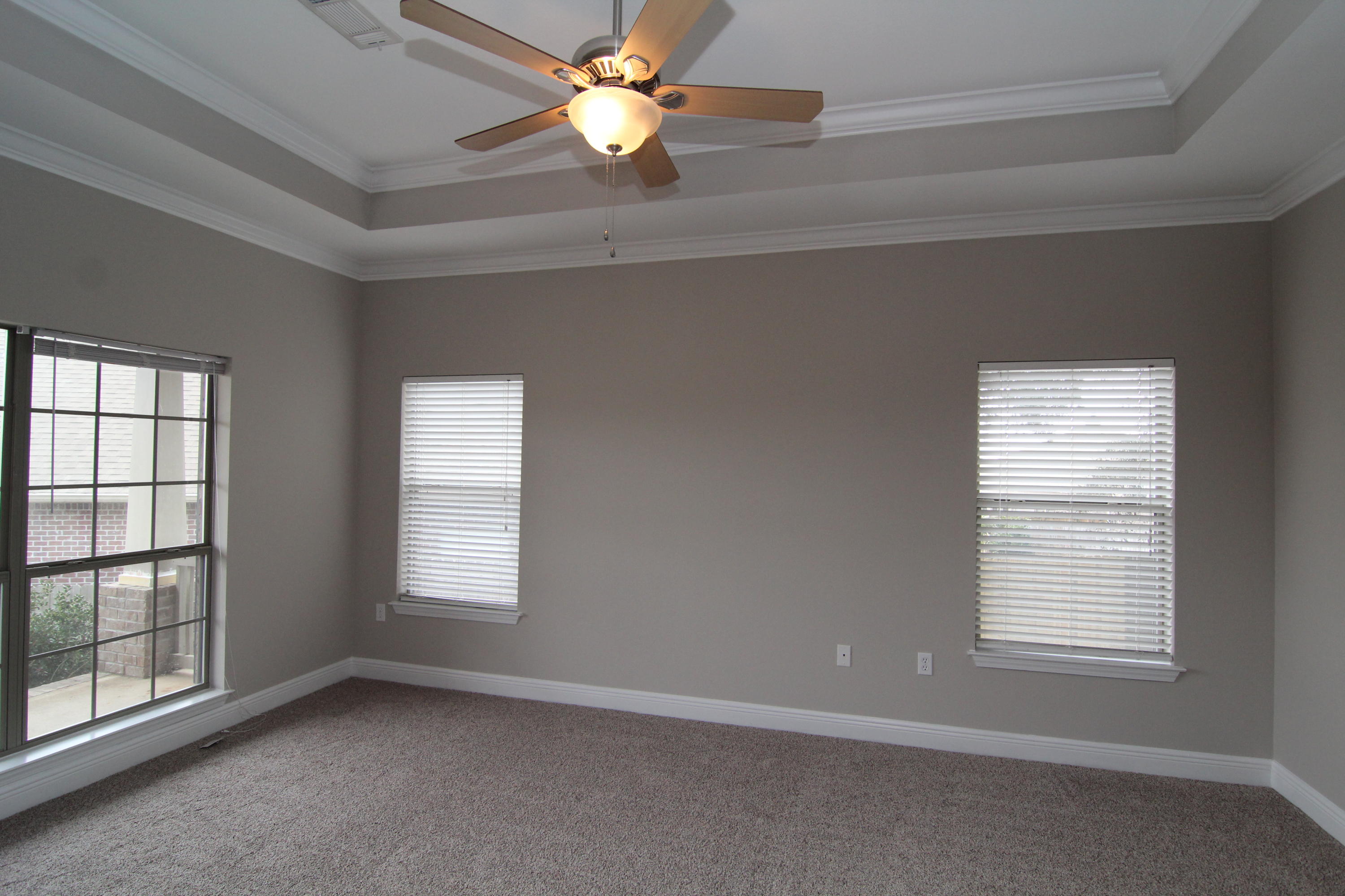 607 Rowan Circle Crestview, FL 32536 - Photo 12 of 17 an empty room with windows and fan