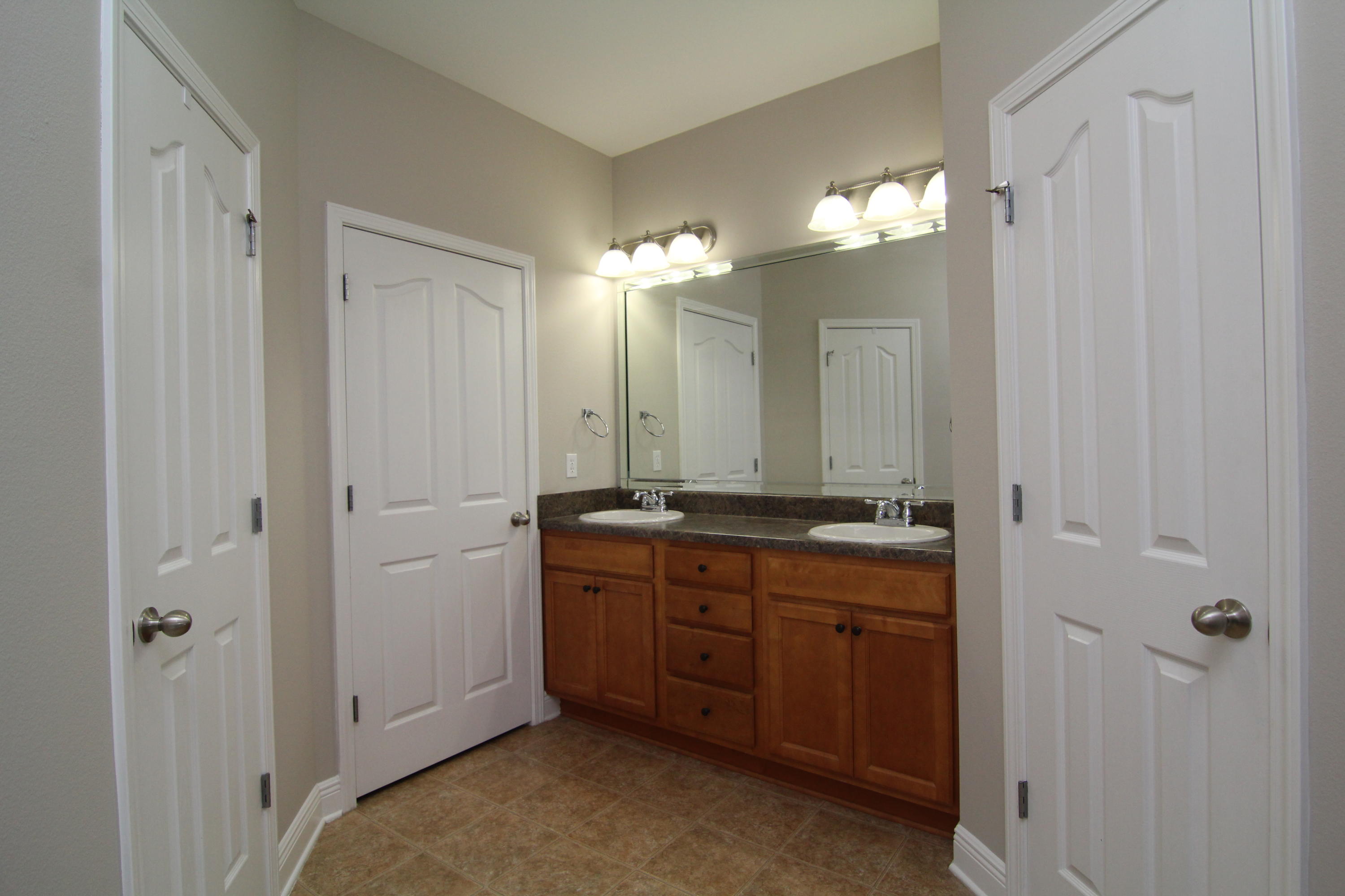 607 Rowan Circle Crestview, FL 32536 - Photo 15 of 17 a bathroom with a double vanity sink and a mirror