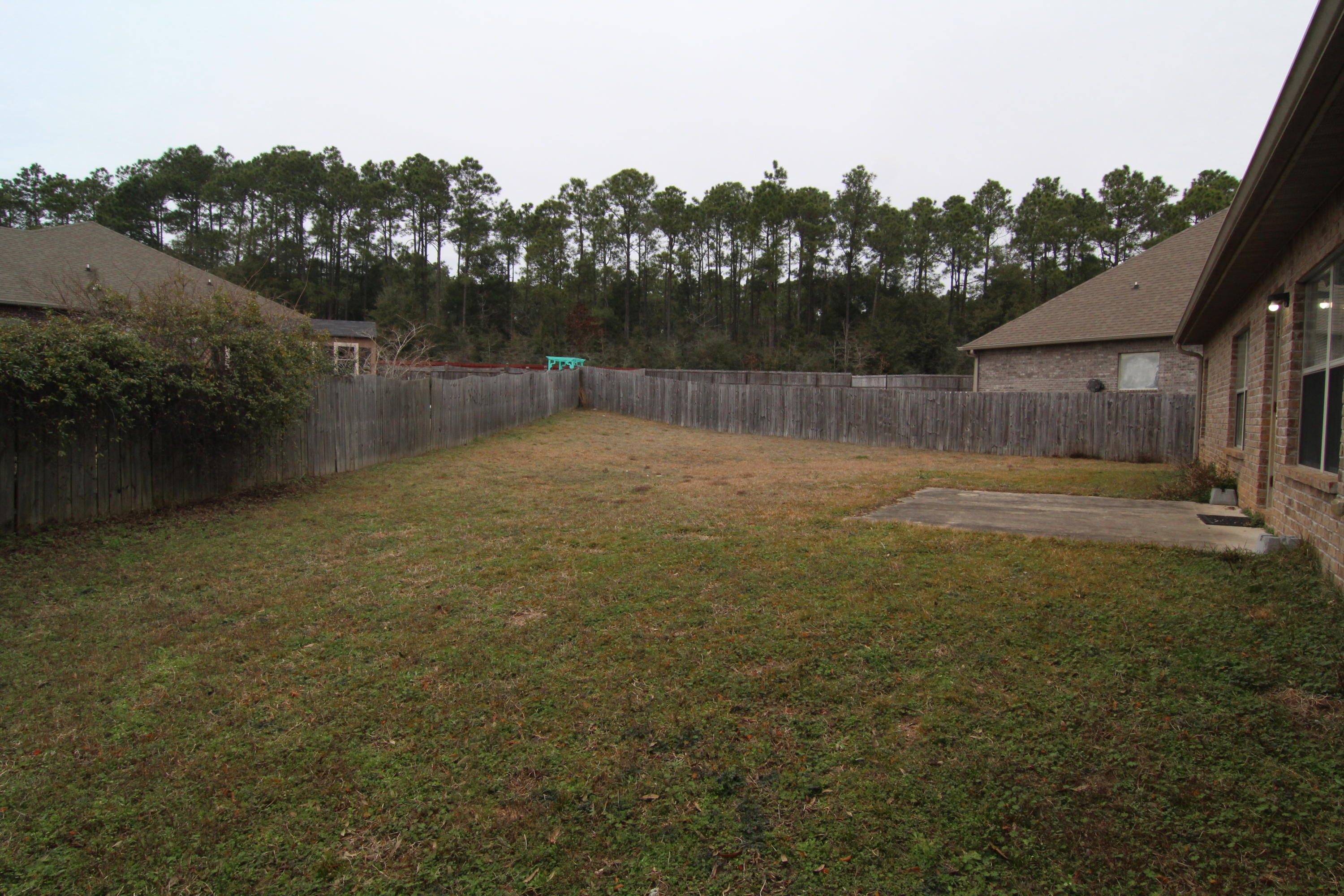 607 Rowan Circle Crestview, FL 32536 - Photo 17 of 17 a backyard of a house with lots of green space