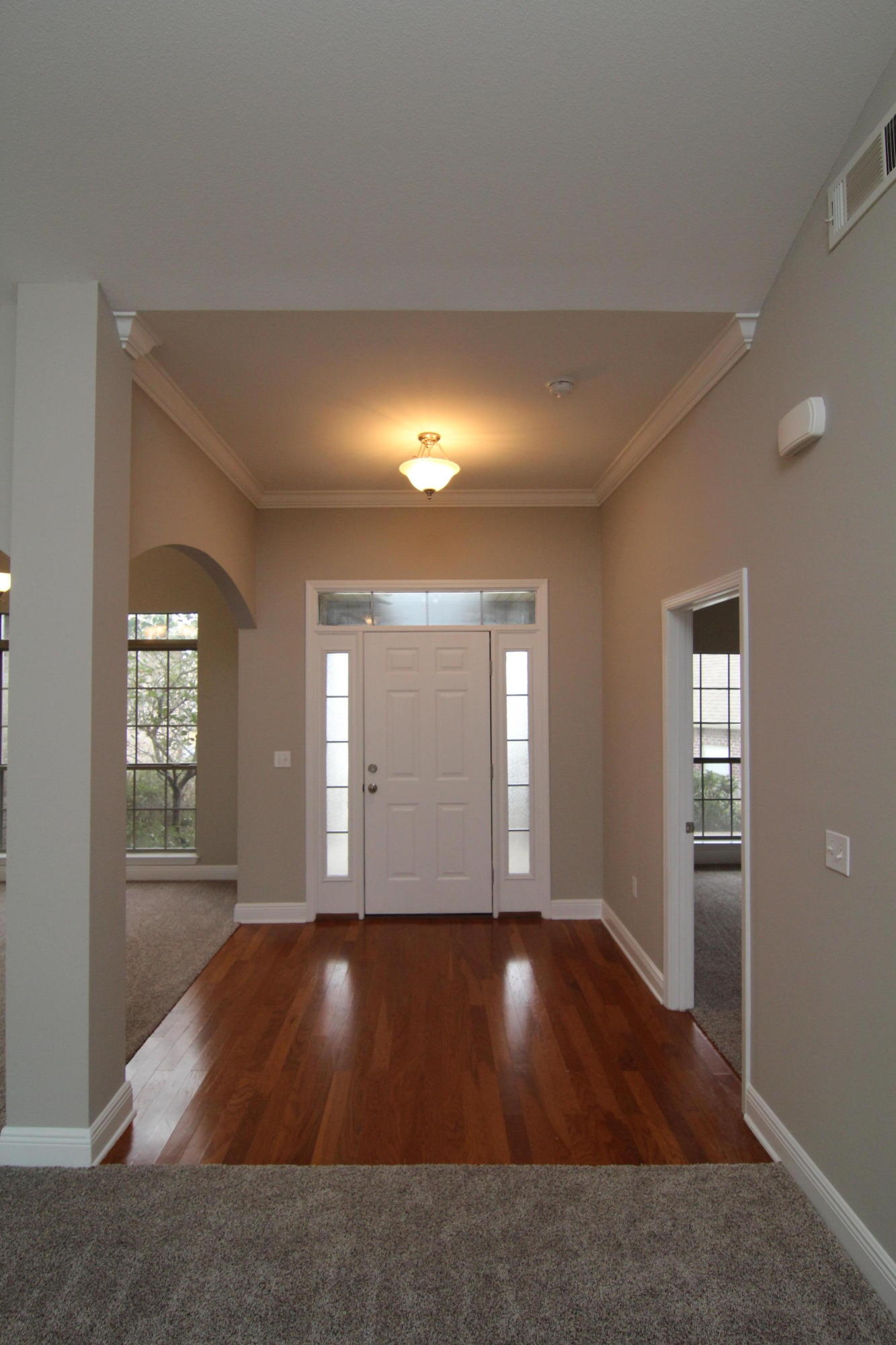 607 Rowan Circle Crestview, FL 32536 - Photo 3 of 17 wooden floor in an empty room with a window