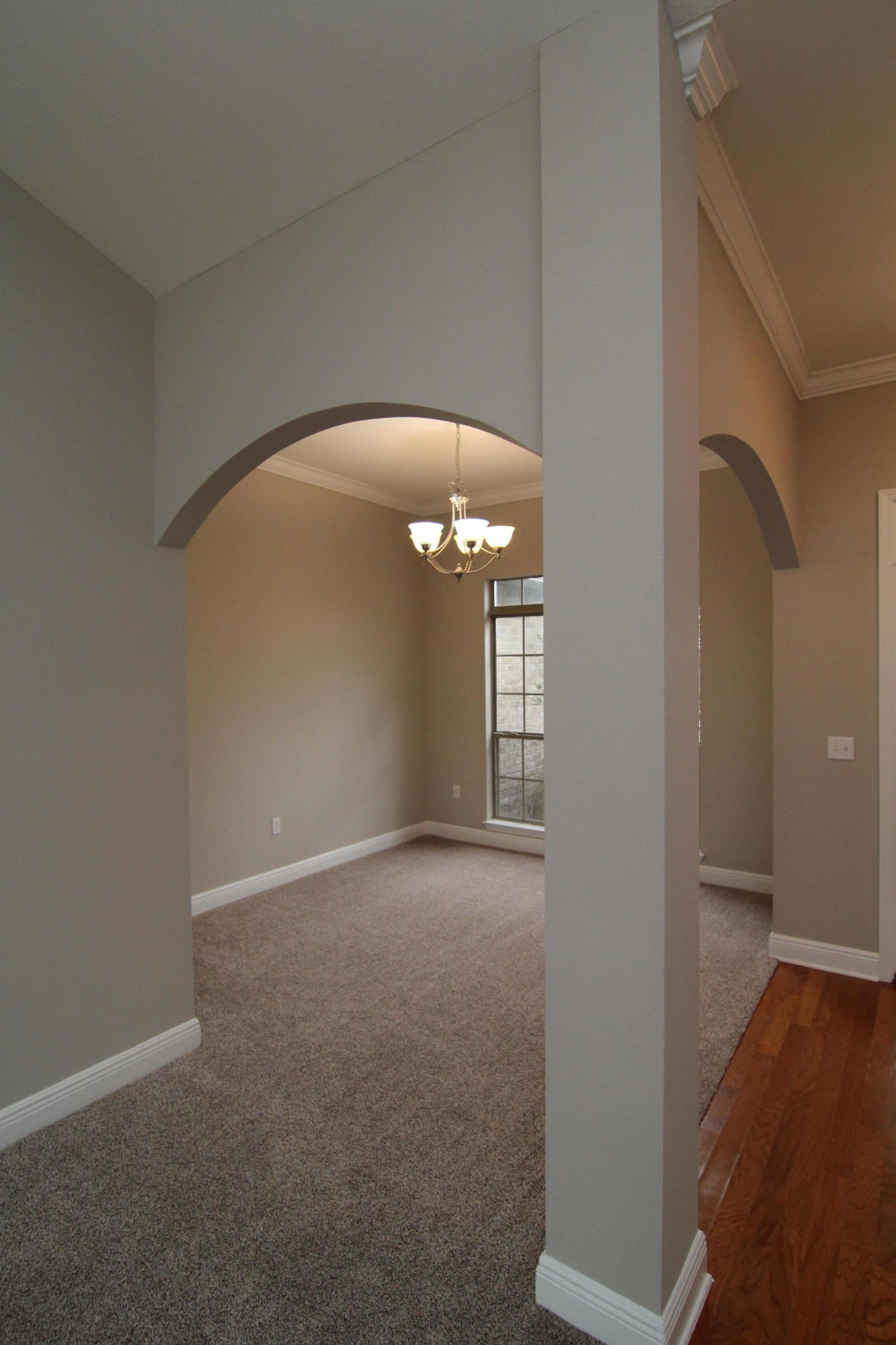 607 Rowan Circle Crestview, FL 32536 - Photo 4 of 17 an empty room with wooden floor and windows