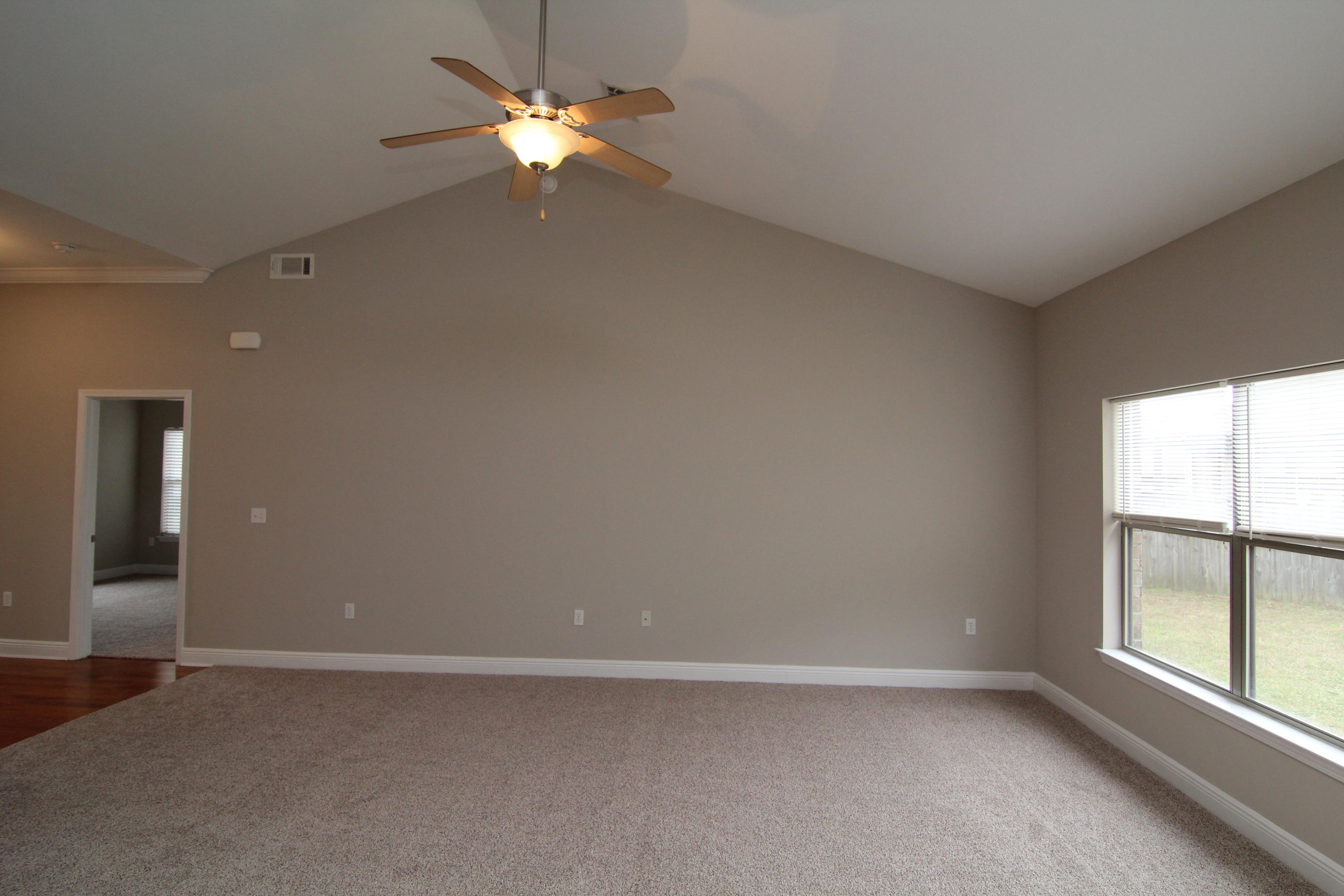 607 Rowan Circle Crestview, FL 32536 - Photo 5 of 17 wooden floor in an empty room with a window