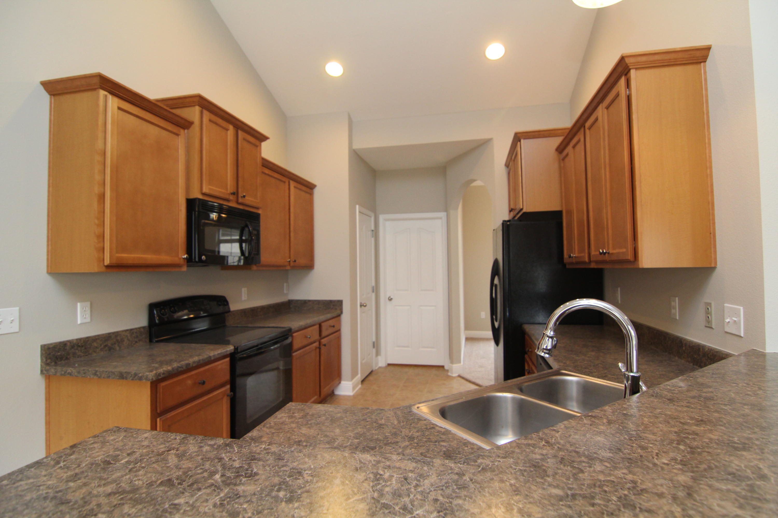 607 Rowan Circle Crestview, FL 32536 - Photo 6 of 17 a kitchen with stainless steel appliances granite countertop a sink stove and refrigerator