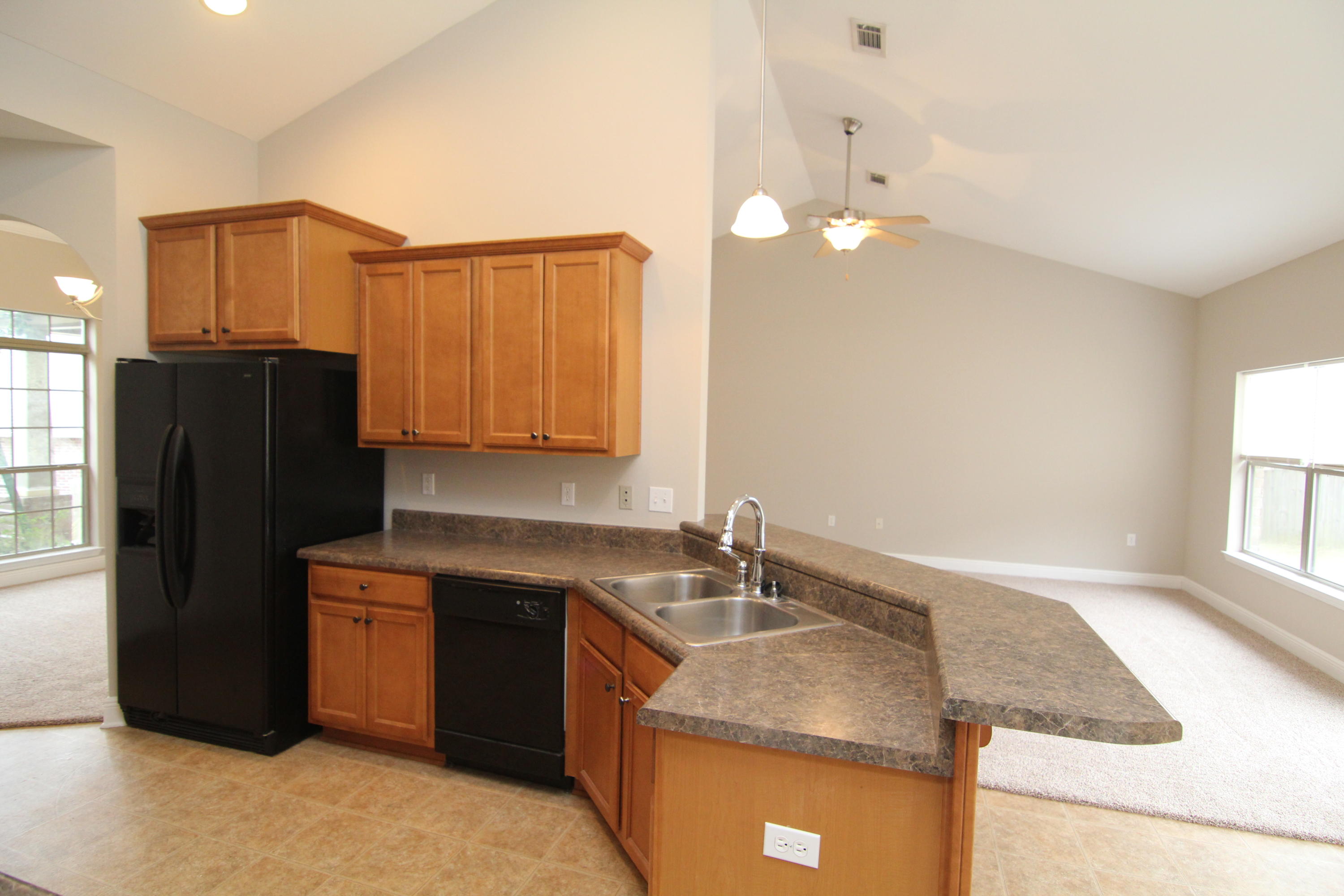 607 Rowan Circle Crestview, FL 32536 - Photo 7 of 17 a kitchen with a sink cabinets and refrigerator