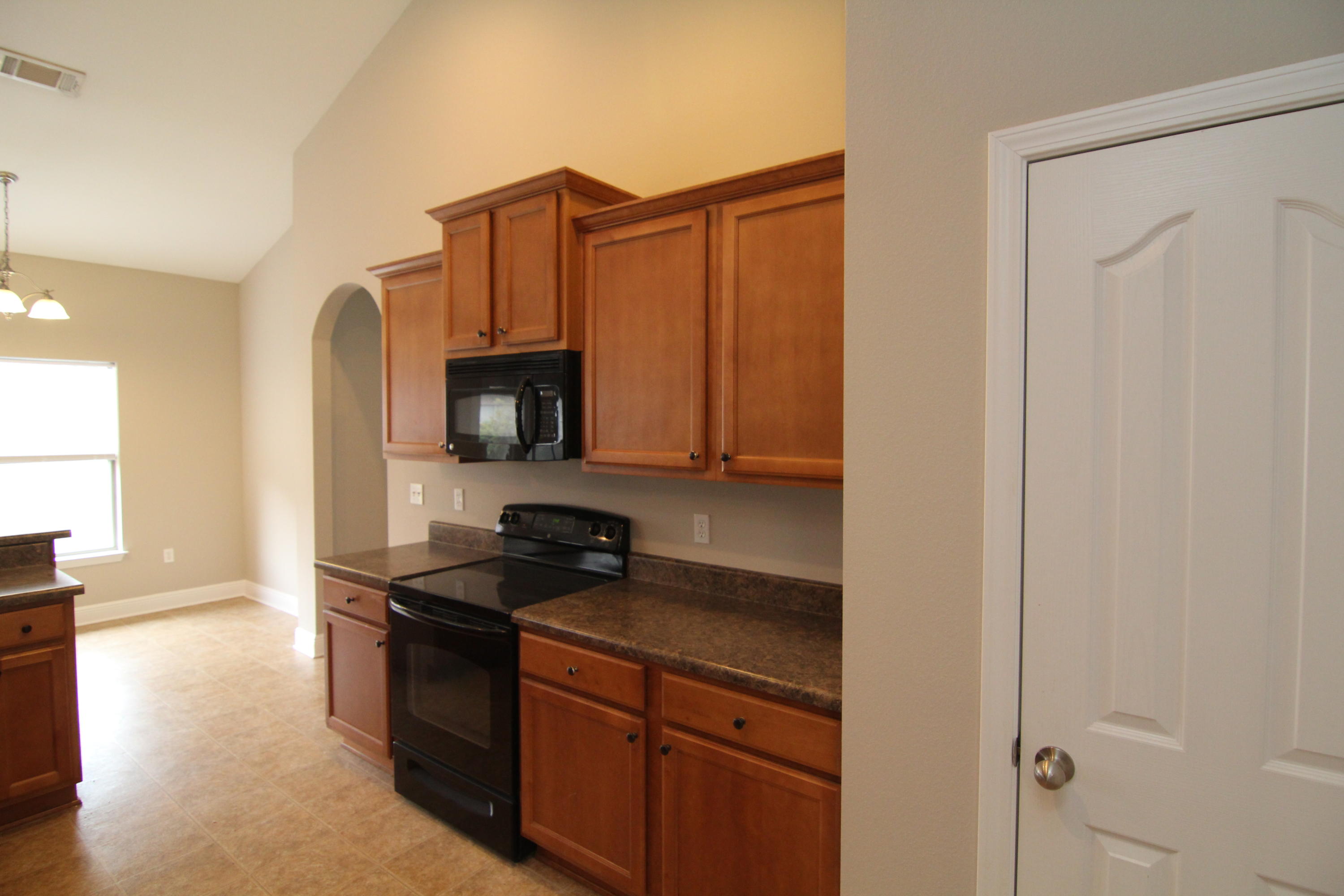 607 Rowan Circle Crestview, FL 32536 - Photo 8 of 17 a kitchen with granite countertop a sink cabinets and stainless steel appliances