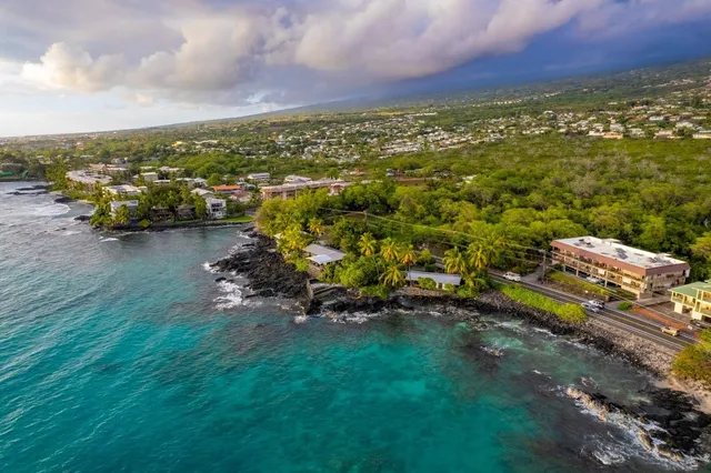 an aerial view of a houses with a yard