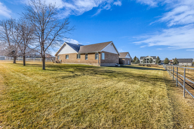 1060 West 2620th Street South Mapleton, UT 84664 - Photo 2 of 87 View of side of property with brick siding and roof with shingles