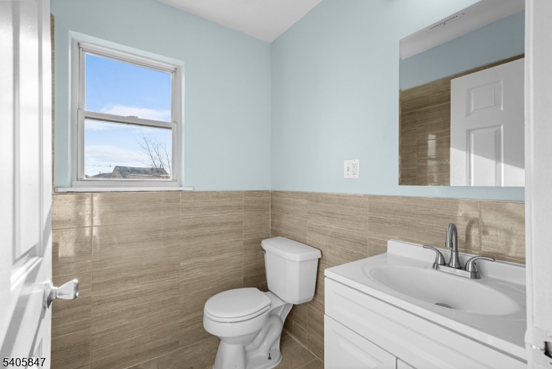 219 Clinton Place Newark, NJ 07112 - Photo 18 of 21 a bathroom with a sink toilet and mirror