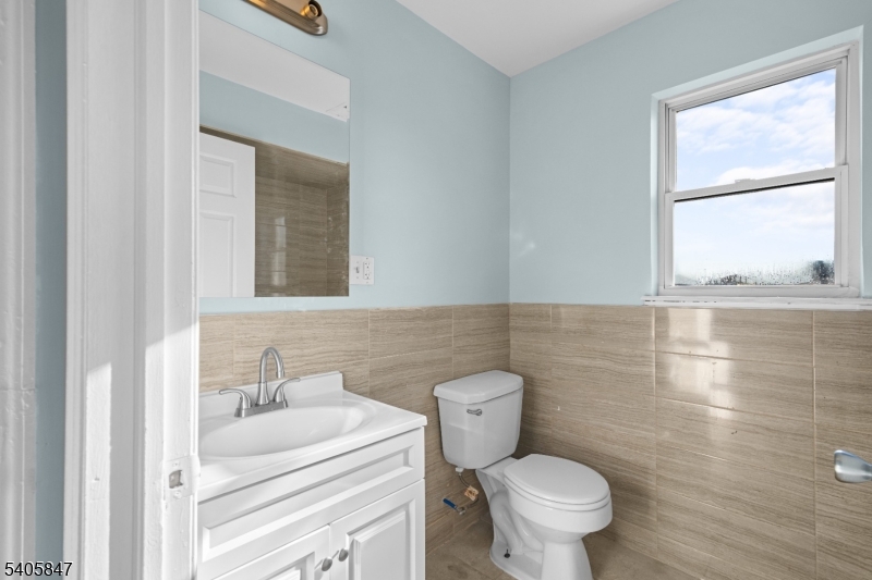 219 Clinton Place Newark, NJ 07112 - Photo 19 of 21 a bathroom with a toilet sink and a mirror