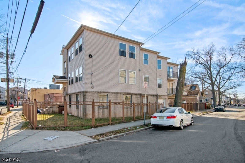 219 Clinton Place Newark, NJ 07112 - Photo 20 of 21 a car parked in front of a building