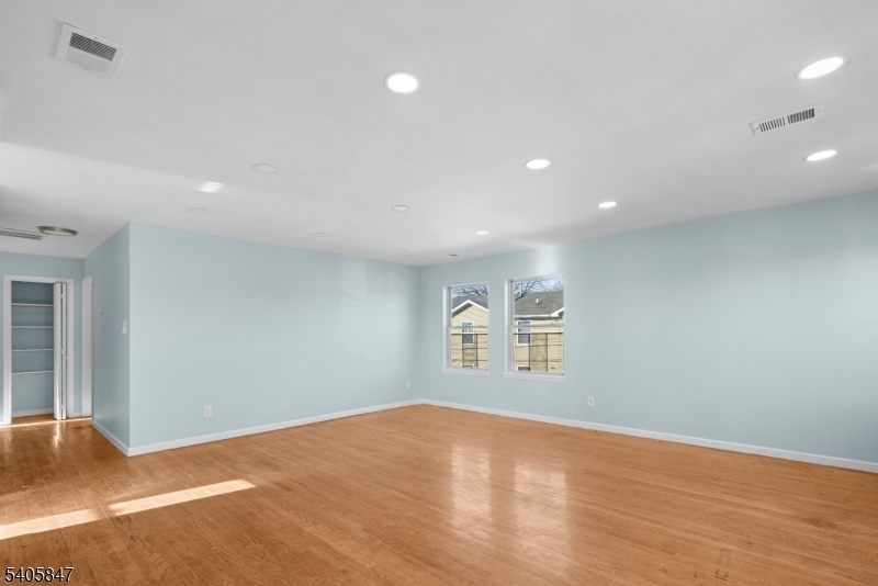 219 Clinton Place Newark, NJ 07112 - Photo 4 of 21 a view of empty room with wooden floor and fan