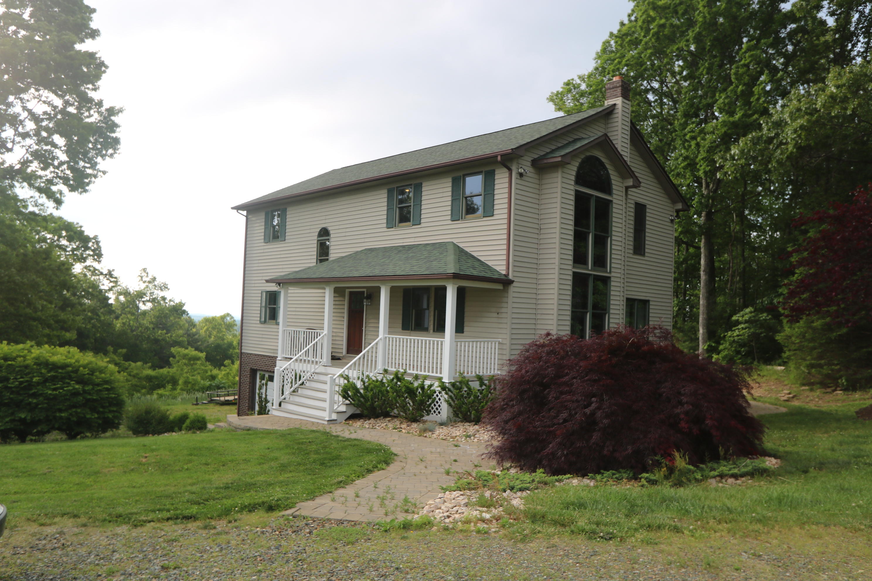 a front view of house with yard and green space