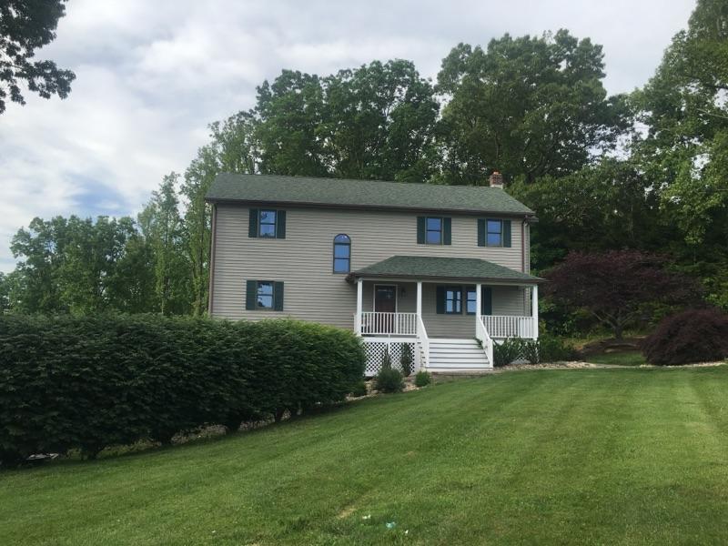 183 Midkiff Road Southeast Floyd, VA 24091 - Photo 2 of 35 a front view of a house with a garden