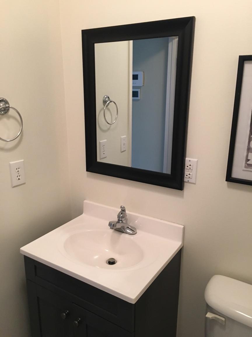 183 Midkiff Road Southeast Floyd, VA 24091 - Photo 13 of 35 a bathroom with a sink a toilet and mirror