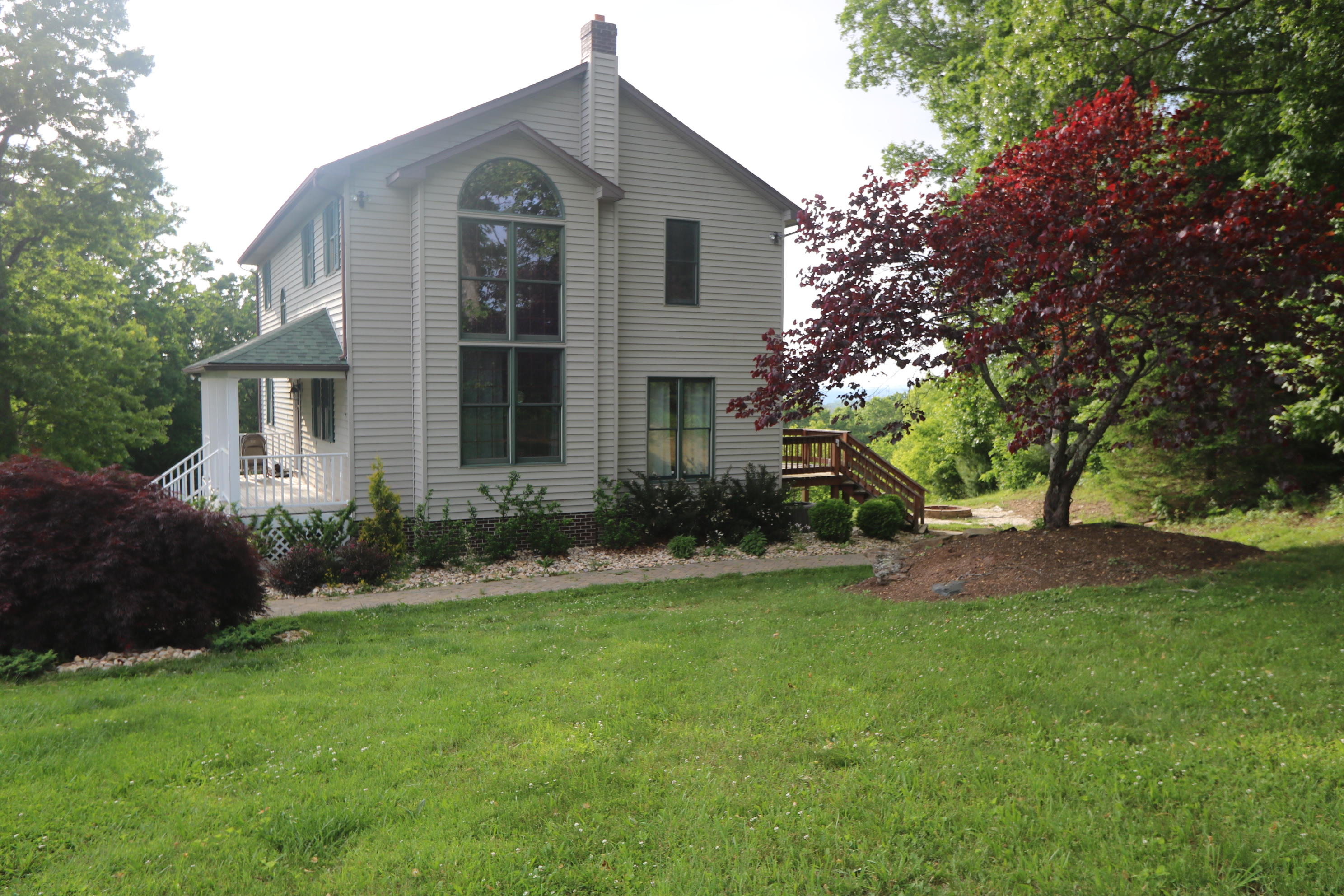 183 Midkiff Road Southeast Floyd, VA 24091 - Photo 3 of 35 a front view of a house with garden