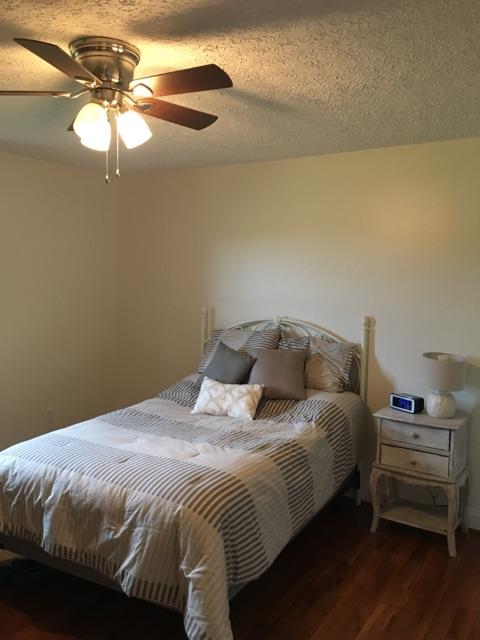 183 Midkiff Road Southeast Floyd, VA 24091 - Photo 21 of 35 a bedroom with a bed and a chandelier