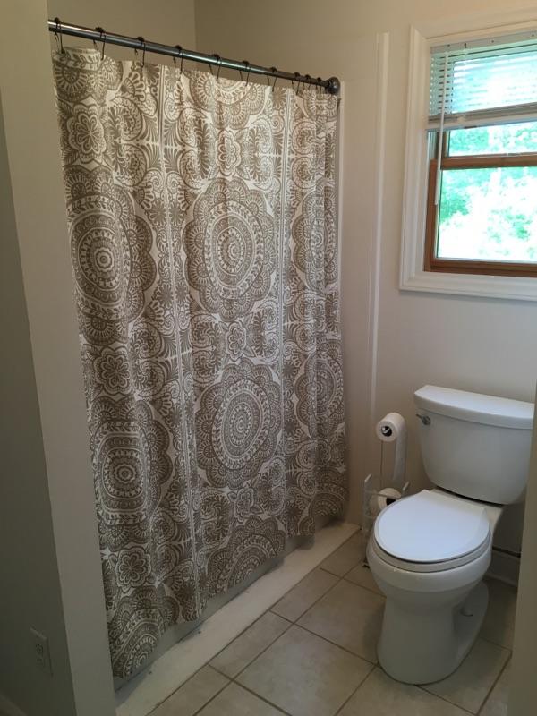 183 Midkiff Road Southeast Floyd, VA 24091 - Photo 25 of 35 a white toilet sitting next to a shower curtain