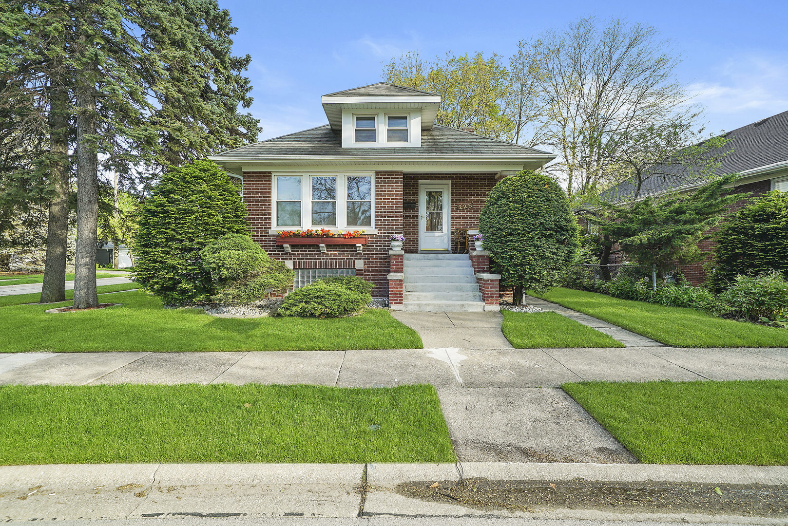 225 East Quincy Street Riverside, IL 60546 - Photo 1 of 32 a house view with a garden space