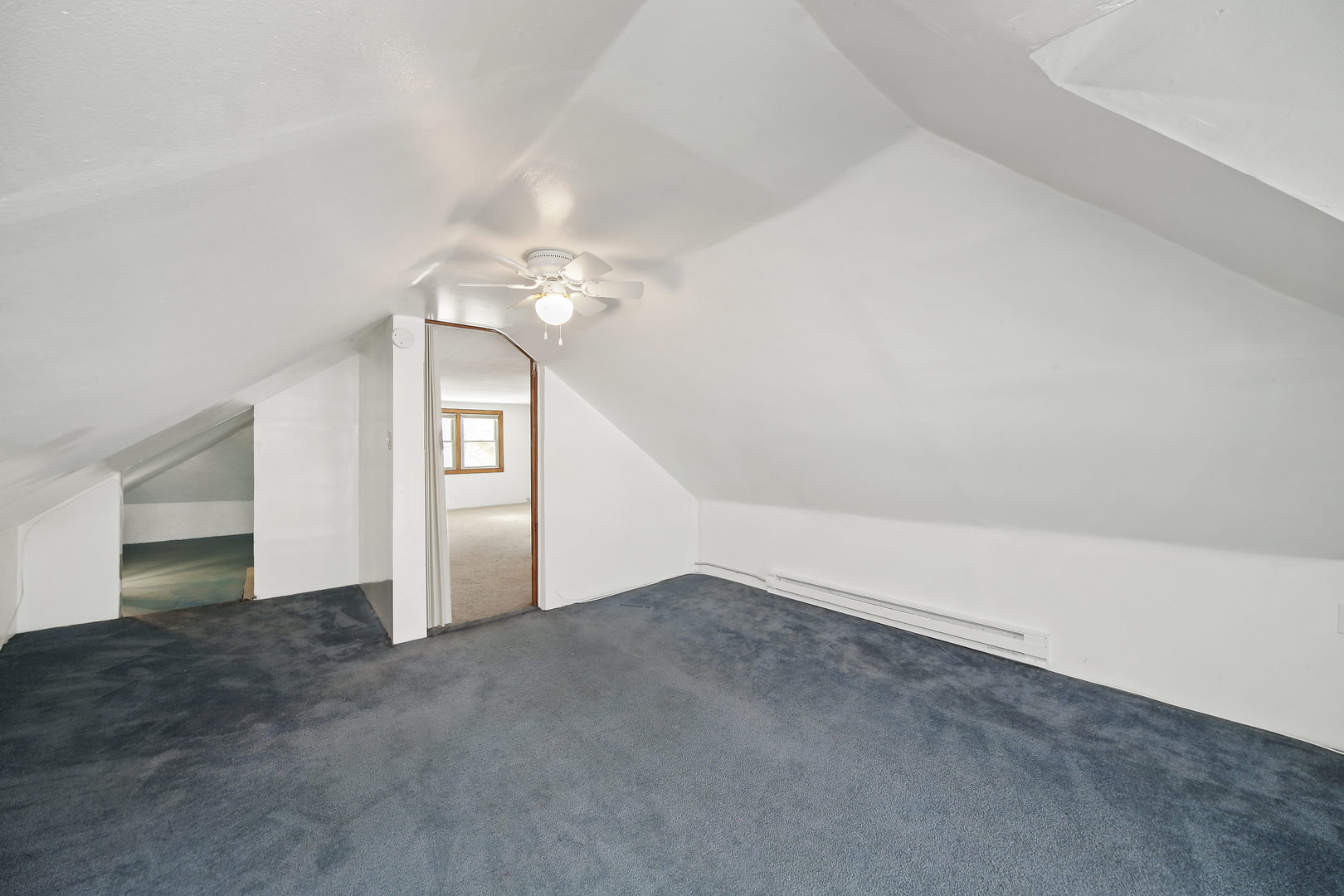 225 East Quincy Street Riverside, IL 60546 - Photo 18 of 32 an empty room with a chandelier fan and windows