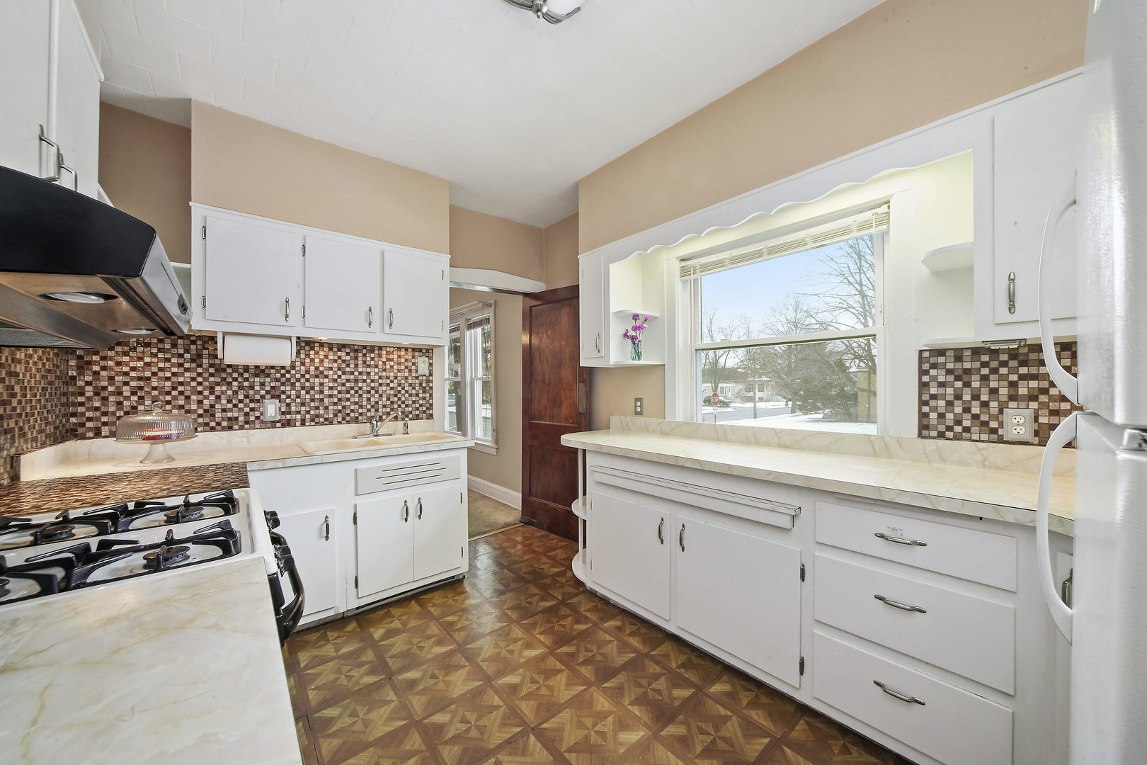 225 East Quincy Street Riverside, IL 60546 - Photo 9 of 32 a kitchen with a stove window and cabinets