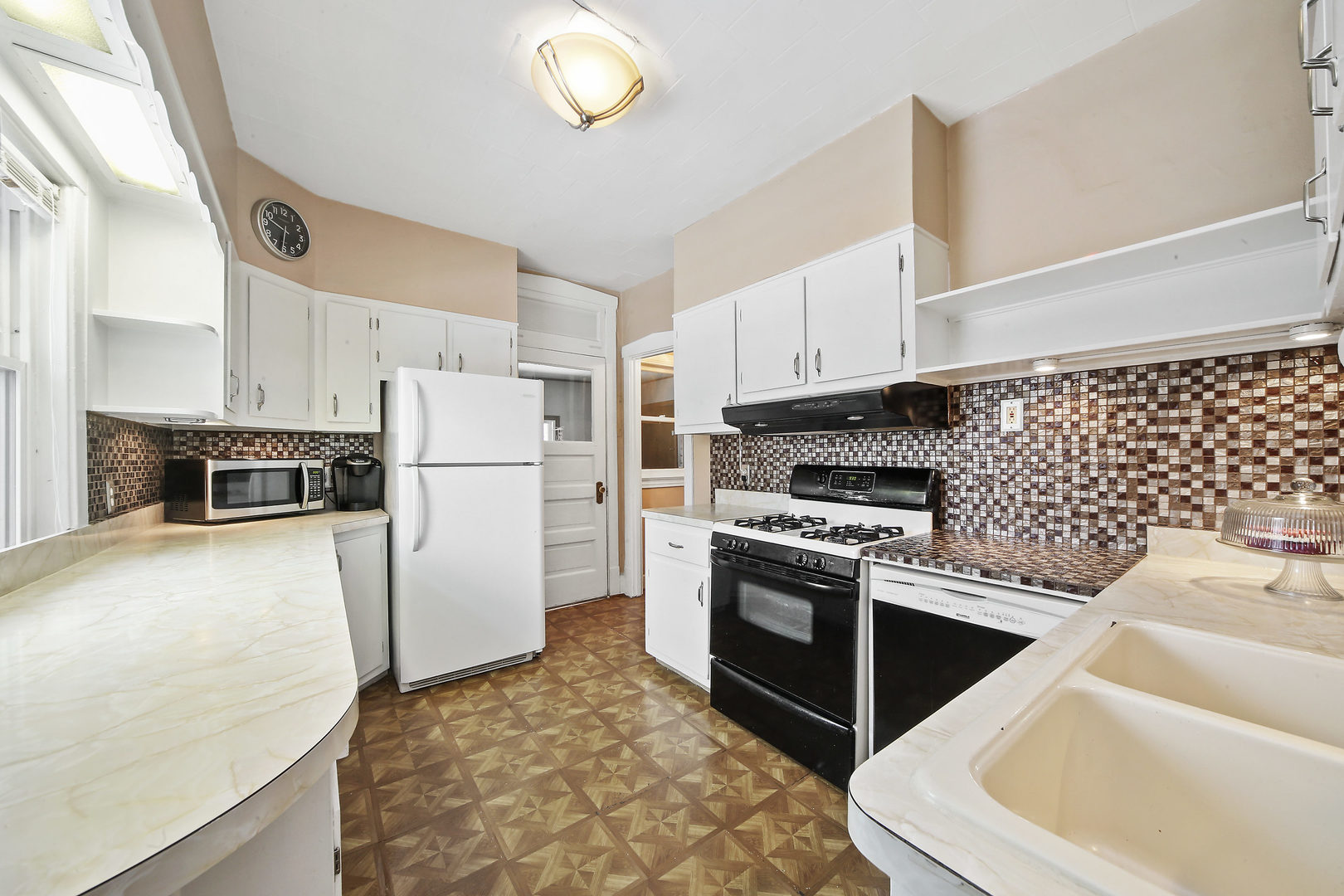 225 East Quincy Street Riverside, IL 60546 - Photo 10 of 32 a kitchen with stainless steel appliances granite countertop a refrigerator sink and stove