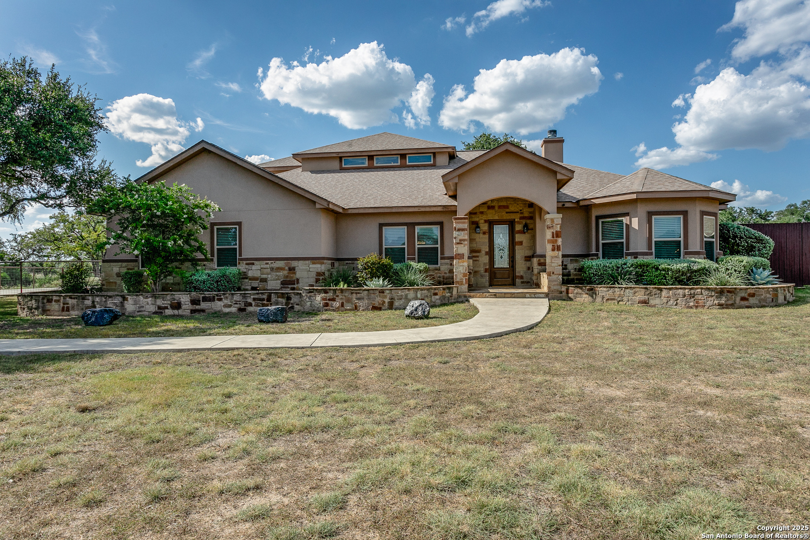 1118 Springfield Drive Spring Branch, TX 78070 - Photo 4 of 31 a front view of a house with garden