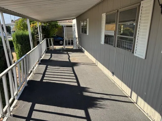 a view of balcony with wooden floor and furniture