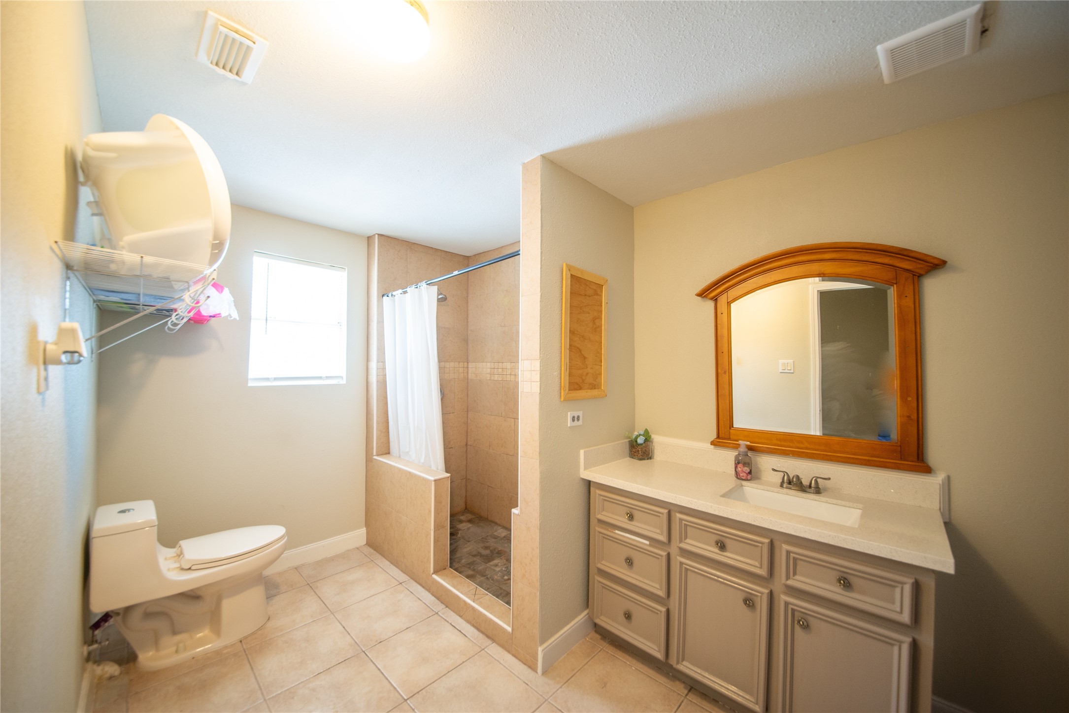 6309 East Houston Road Houston, TX 77028 - Photo 17 of 17 a bathroom with a double vanity sink mirror and toilet