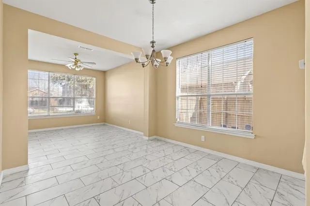 a view of an empty room with windows