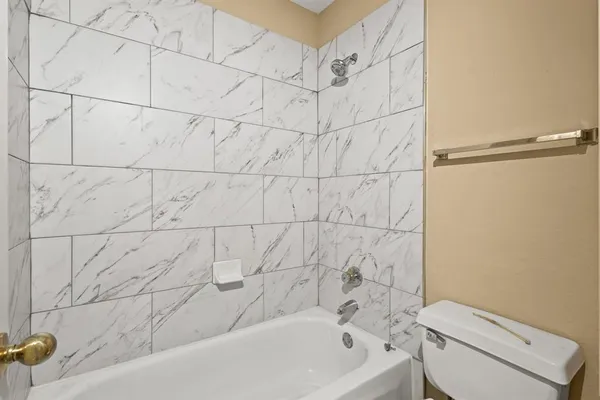 a bathroom with a bathtub and a toilet