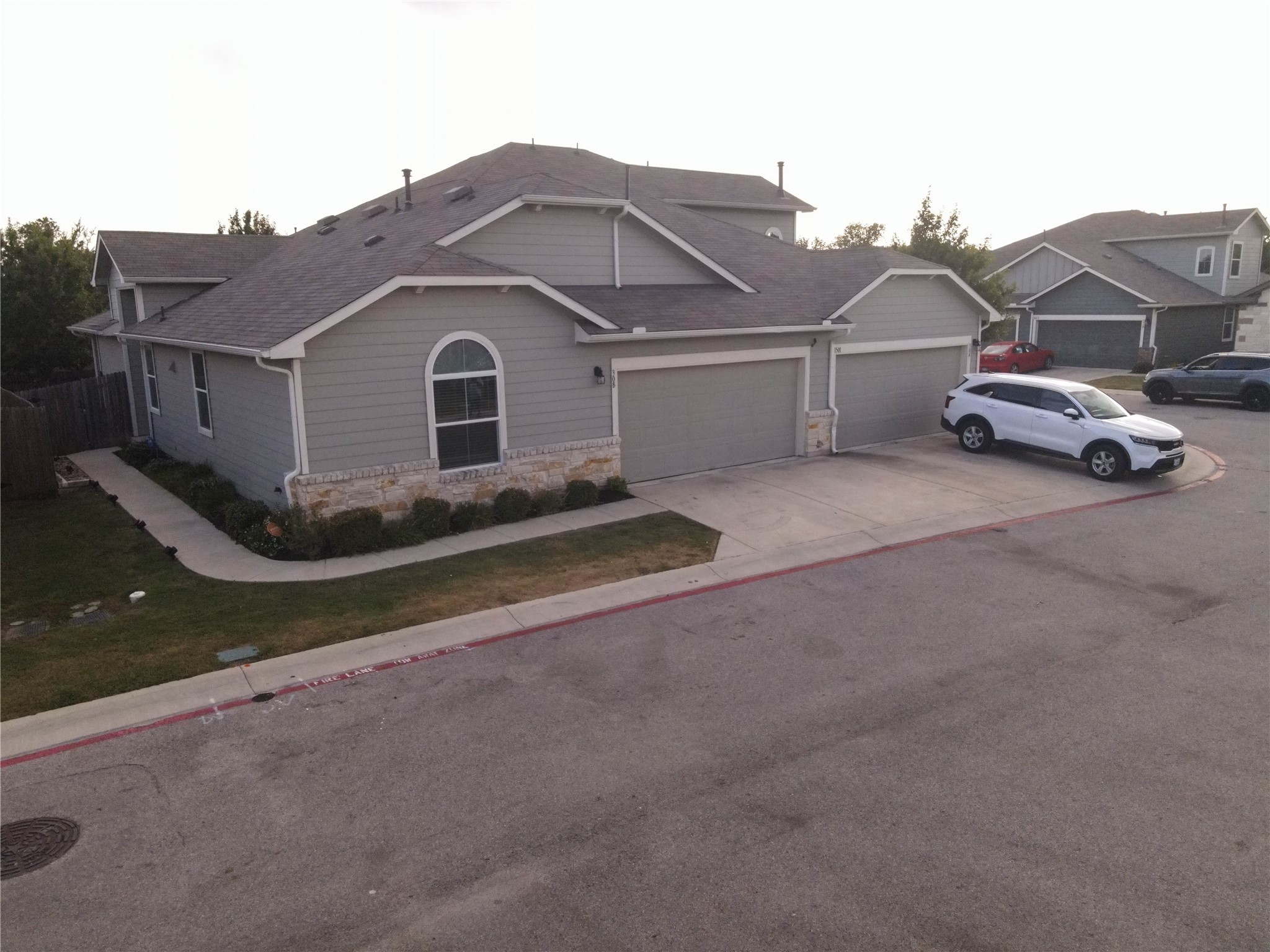 1501 Gropius Lane, Unit 30B Pflugerville, TX 78660 - Photo 2 of 30 Craftsman inspired home with an attached garage, stone siding, a shingled roof, and concrete driveway
