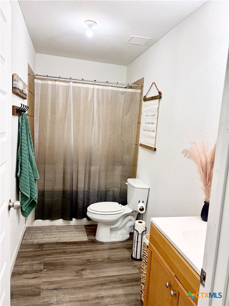 950 Highsmith Road Luling, TX 78648 - Photo 13 of 36 a bathroom with a sink toilet and shower
