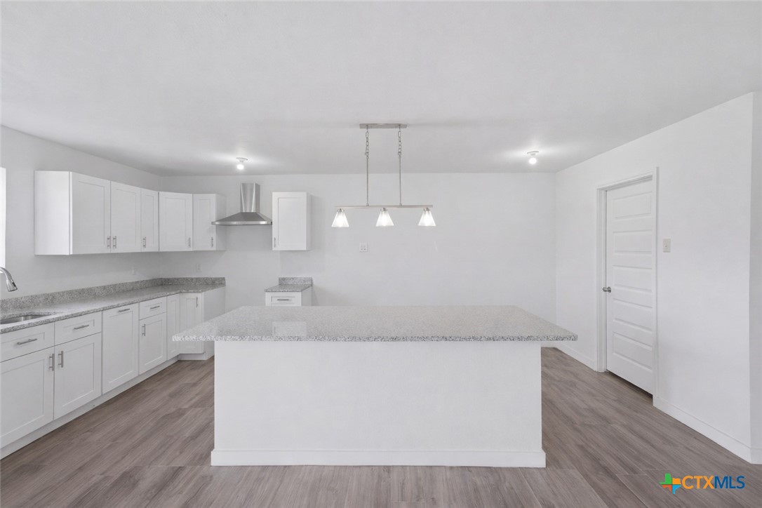 950 Highsmith Road Luling, TX 78648 - Photo 14 of 36 a view of a kitchen counter space and wooden floor