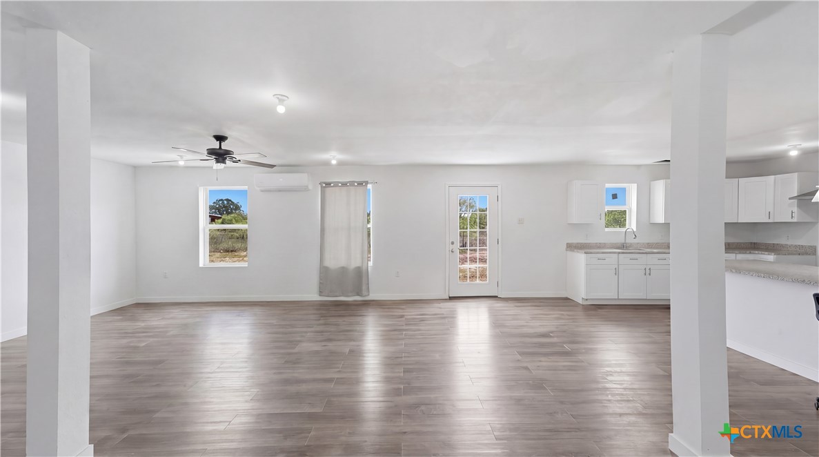 950 Highsmith Road Luling, TX 78648 - Photo 18 of 36 a view of an empty room with window and wooden floor