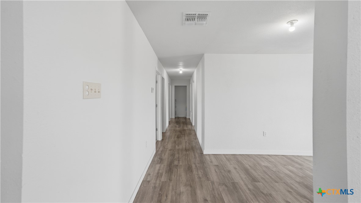 950 Highsmith Road Luling, TX 78648 - Photo 19 of 36 a view of a hallway with wooden floor
