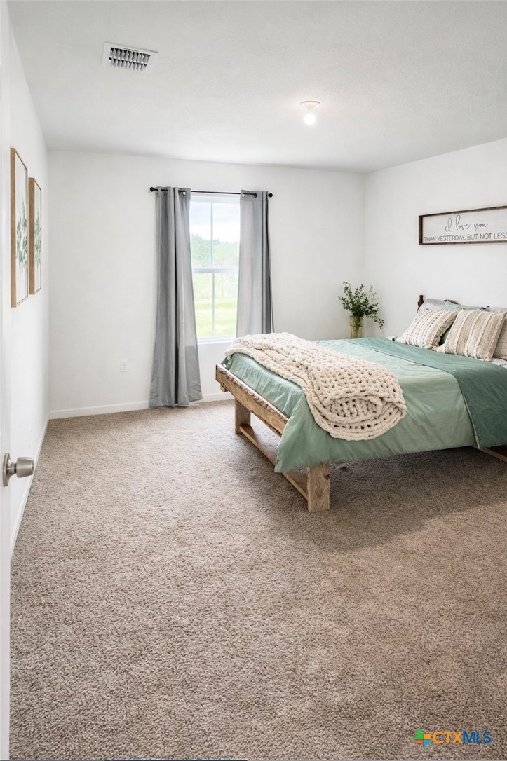 950 Highsmith Road Luling, TX 78648 - Photo 10 of 36 a spacious bedroom with a bed and a window