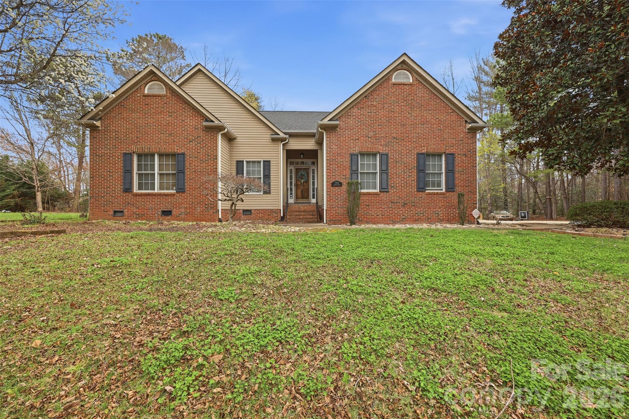 a front view of house with yard and green space