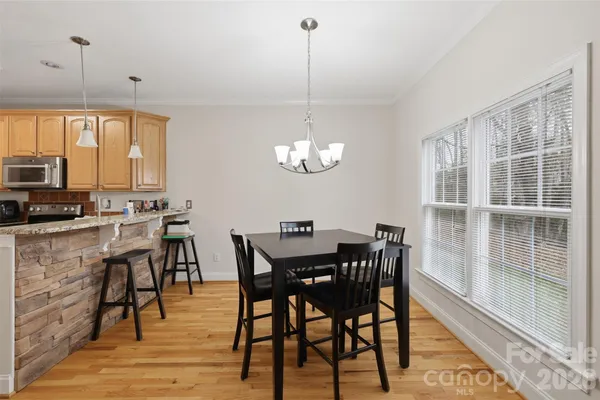a view of a dining room with furniture window and wooden floor