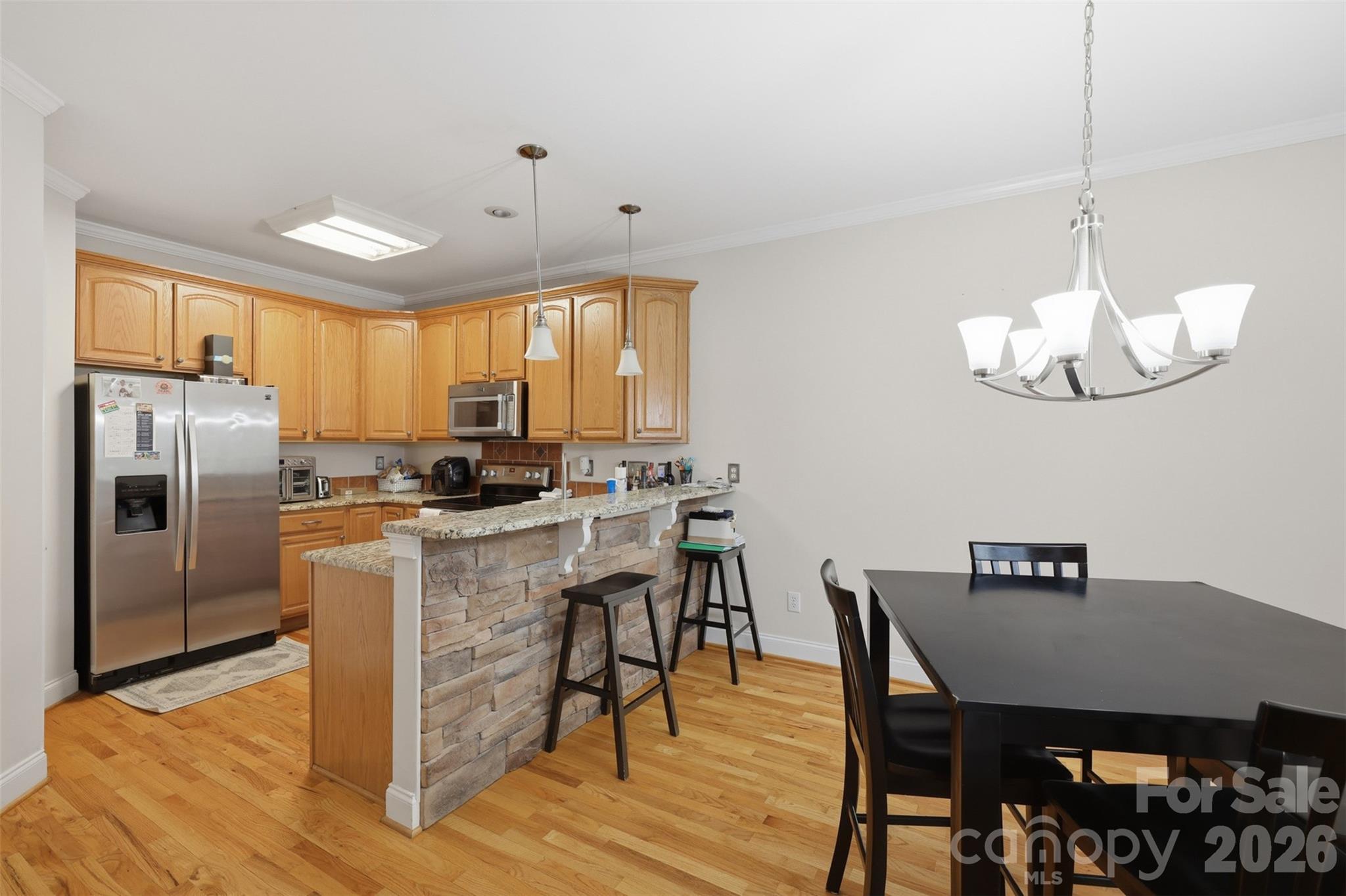 7594 Church Road Taylorsville, NC 28681 - Photo 17 of 34 a kitchen with a dining table chairs stainless steel appliances and cabinets