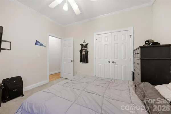 a bedroom with a bed and a chandelier