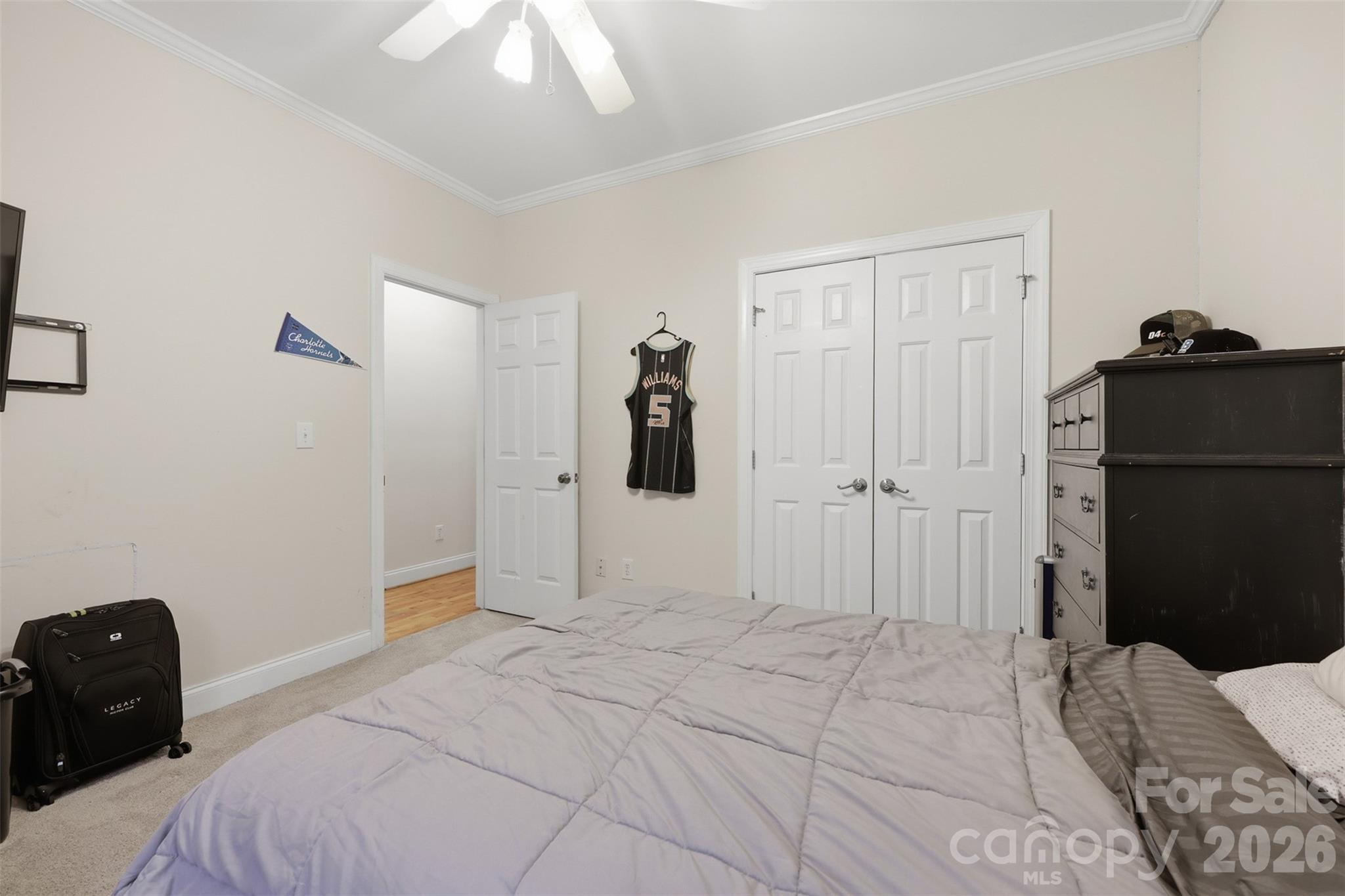 7594 Church Road Taylorsville, NC 28681 - Photo 28 of 34 a bedroom with a bed and a chandelier