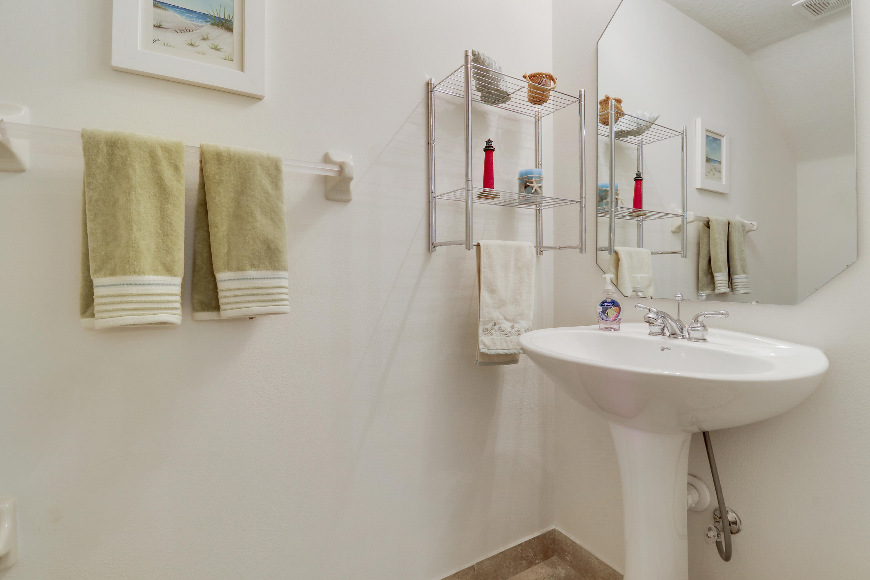 5410 Southeast Mitchell Lane Stuart, FL 34997 - Photo 14 of 24 a bathroom with a sink and a mirror