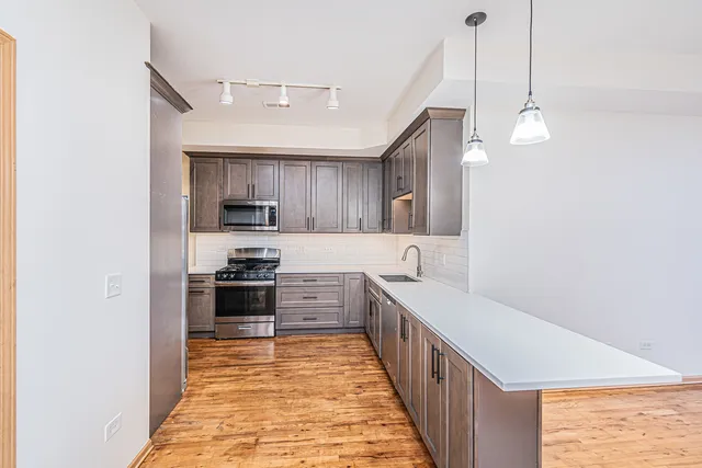 a kitchen with stainless steel appliances granite countertop a sink and cabinets