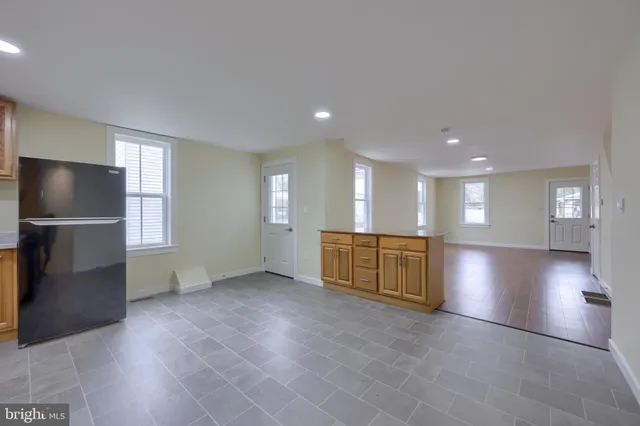 a view of an empty room with a kitchen