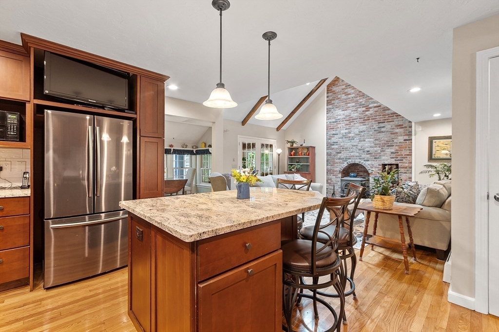 31 Spectacle Hill Road Bolton, MA 01740 - Photo 2 of 42 a kitchen with stainless steel appliances granite countertop sink refrigerator dining table and chairs
