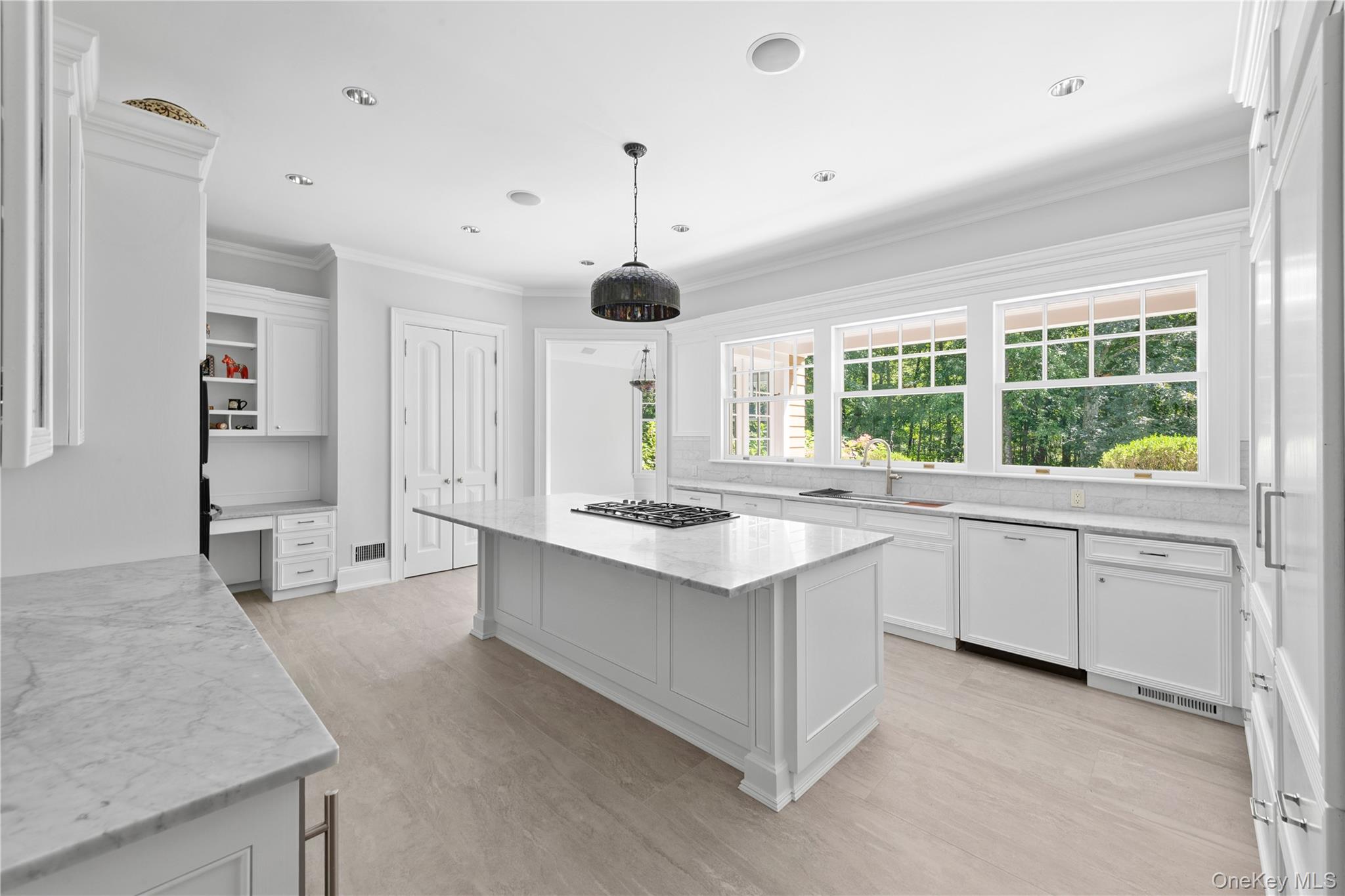 284 West Patent Road Bedford, NY 10549 - Photo 6 of 40 Kitchen with white cabinets, ornamental molding, light stone countertops, dishwasher, and decorative backsplash